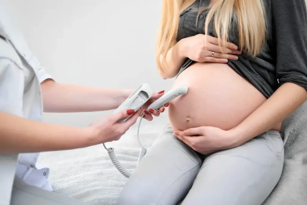 doctor-performing-ultrasound-scanning-her-pregnant-patient-scaled